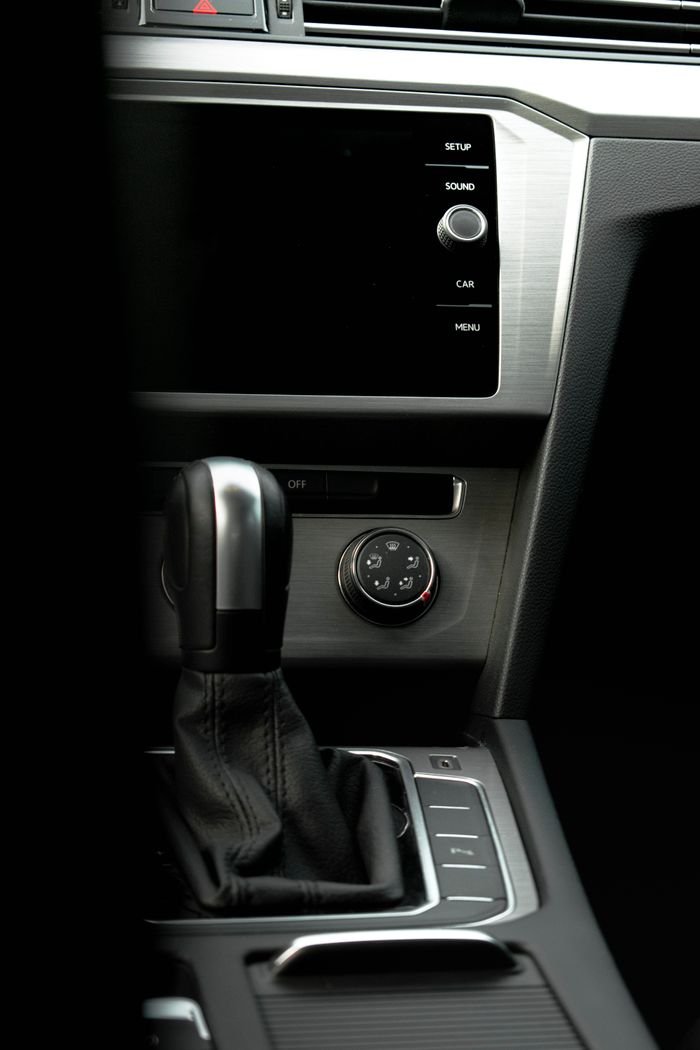 Close-up of a modern car's interior featuring the gear shift and digital dashboard display.