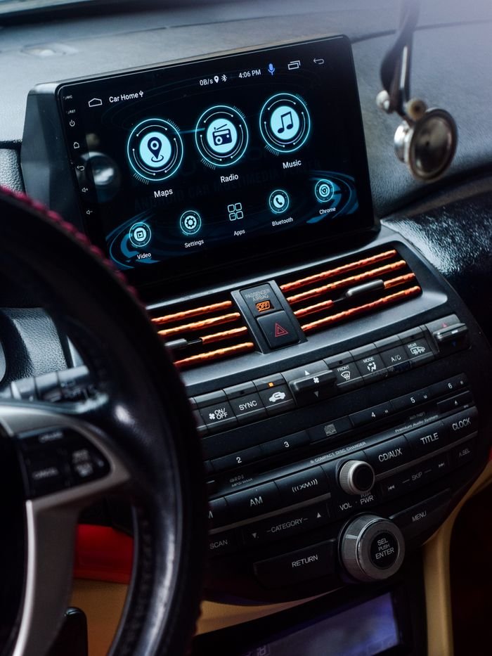 Detailed view of a car dashboard with a digital touchscreen display showing maps, radio, and music options.