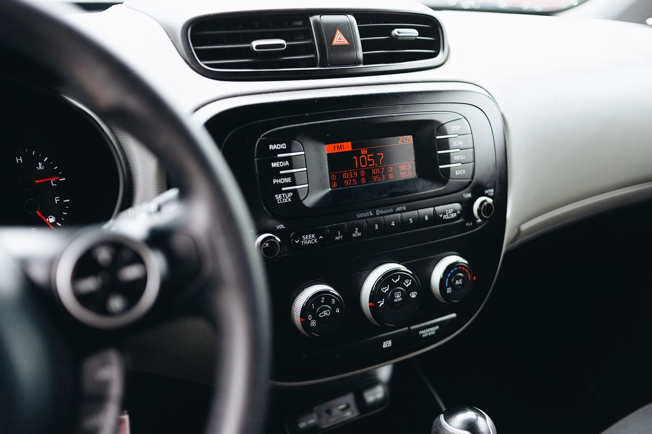 Detailed view of a car's dashboard with stereo and climate controls, showcasing modern interior design.